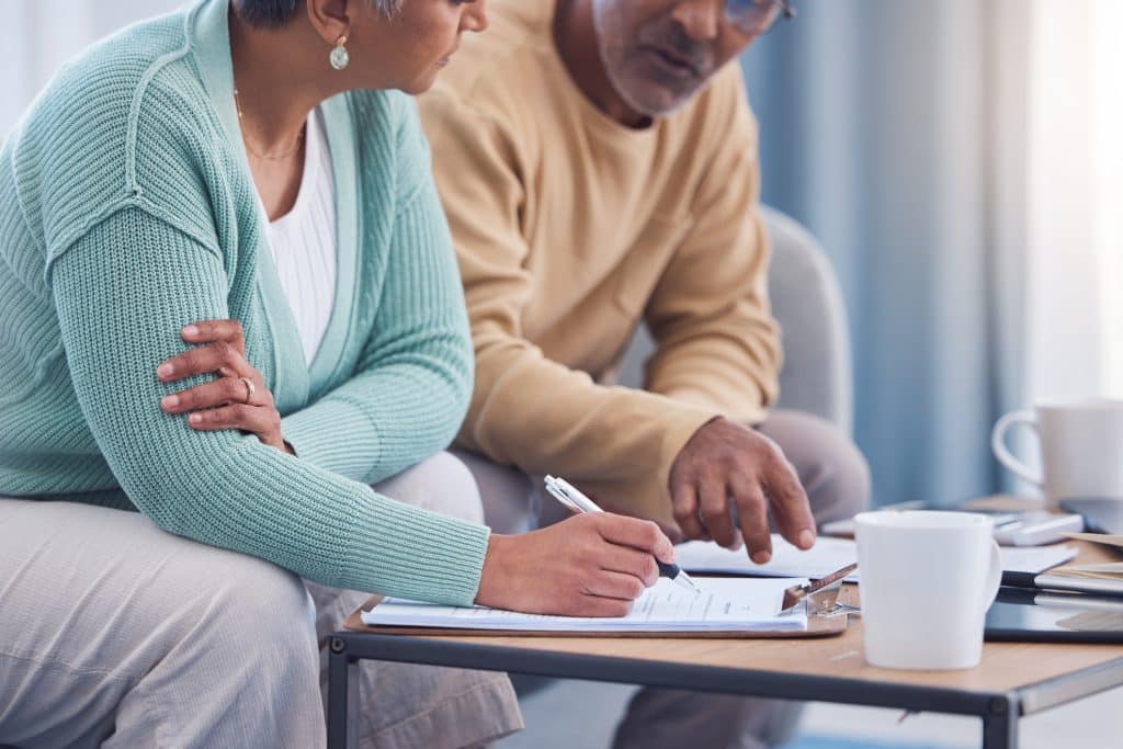 A senior couple works together on their state planning. 