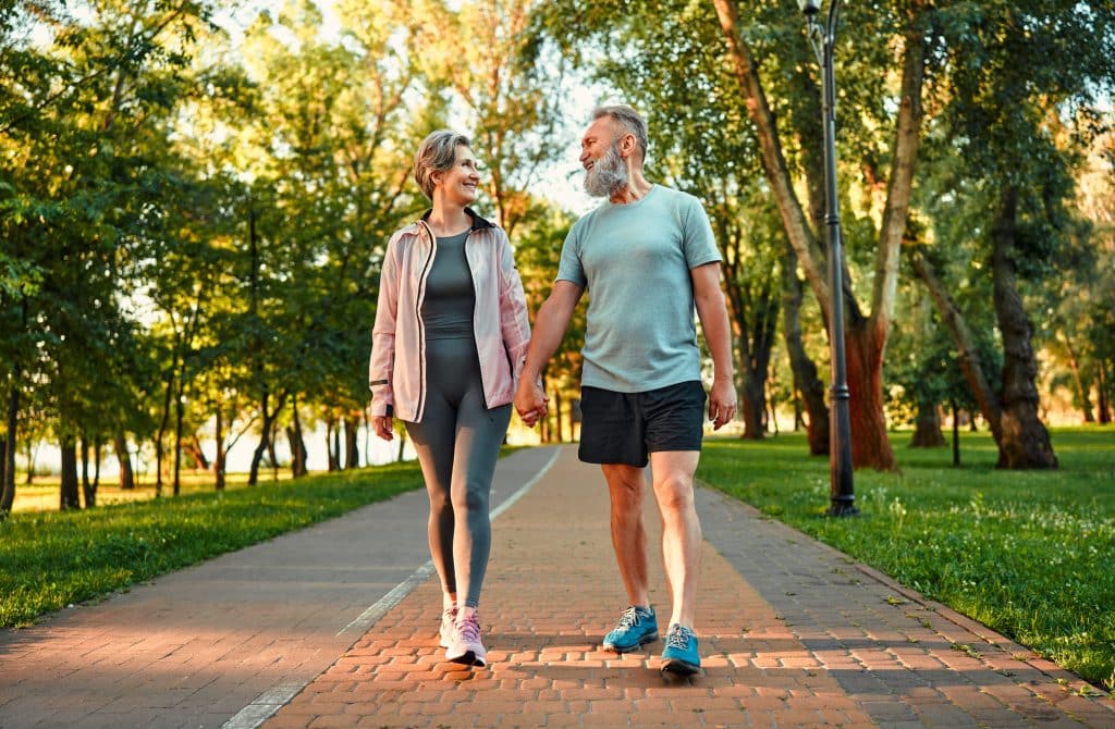 An older couple staying active by going on a morning walk together.