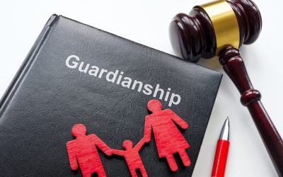 A Notebook With The Word “guardianship” Written On It, Next To A Gavel, Pen, And A Small Figure Of A Family, Representing How The Law Handles Choosing A Guardian.