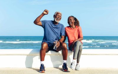 An Older Husband And Wife Feeling Strong After Exercise Near A Sunny Beach; They Represent Healthy Aging.