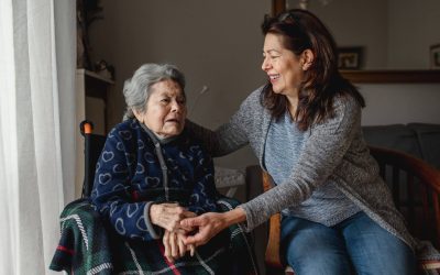 A Woman Sits With Her Elderly Mother As She Considers Becoming A Family Caregiver.