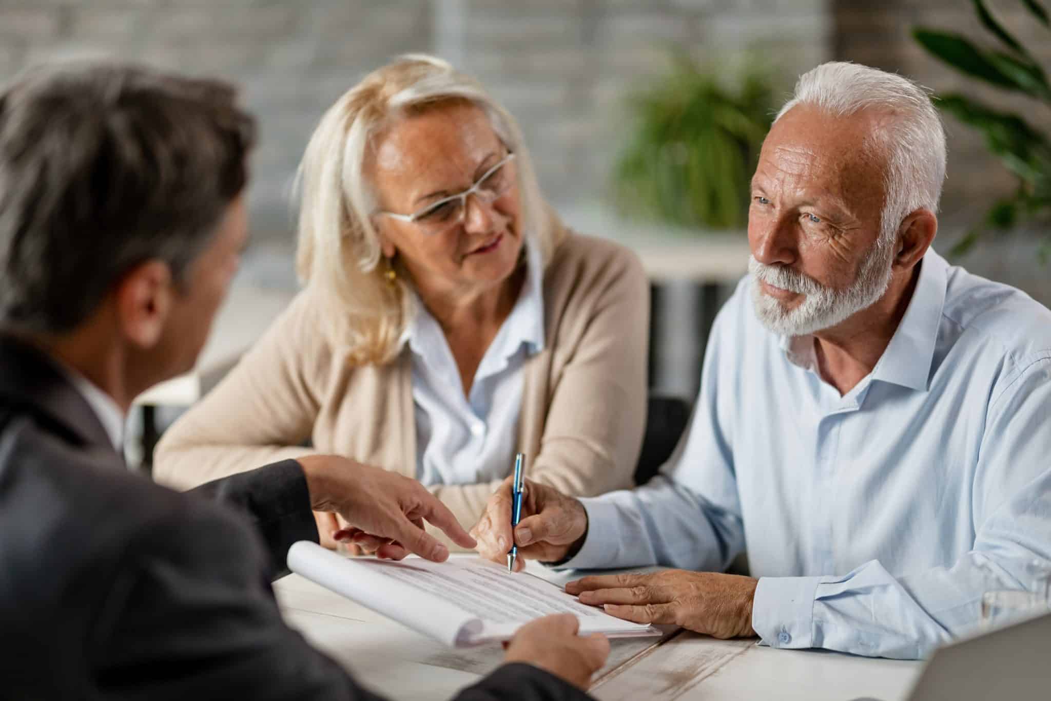 A couple in a domestic partnership works with an estate lawyer on their estate planning documents.