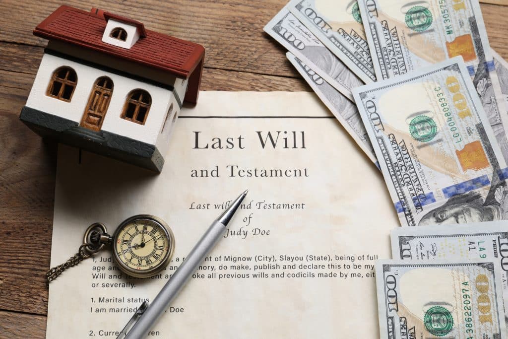 Last will and testament surrounded by other symbols of the probate process. 