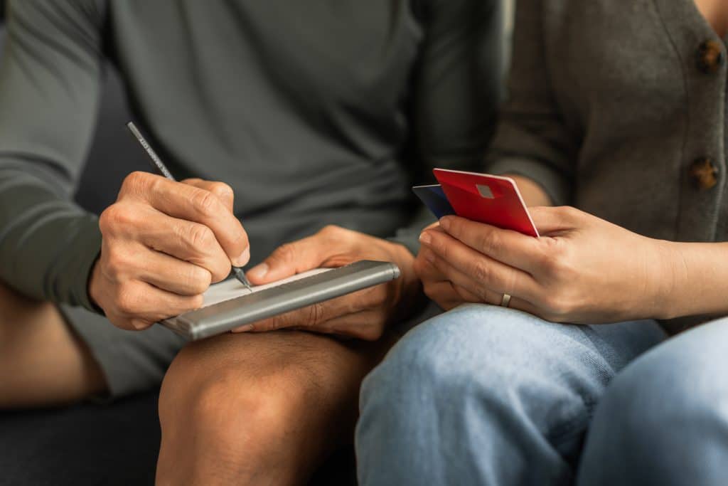 An older couple takes stock of their credit card debt as they prepare their estate planning. 