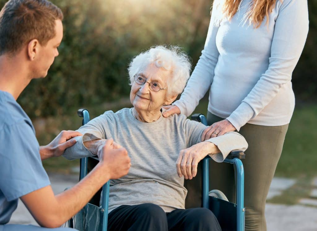 A daughter with her elderly mother at a nursing home, after successful medicaid planning with an elder law attorney.