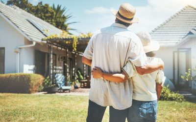 An older couple stands in front of their Kentucky home, which they’ve saved from Medicaid with professional estate planning.