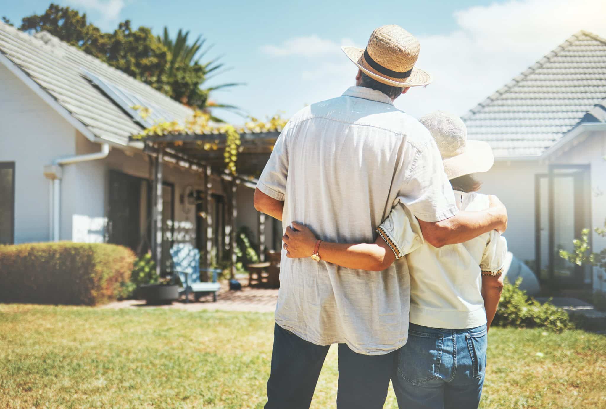 An older couple stands in front of their Kentucky home, which they’ve saved from Medicaid with professional estate planning.